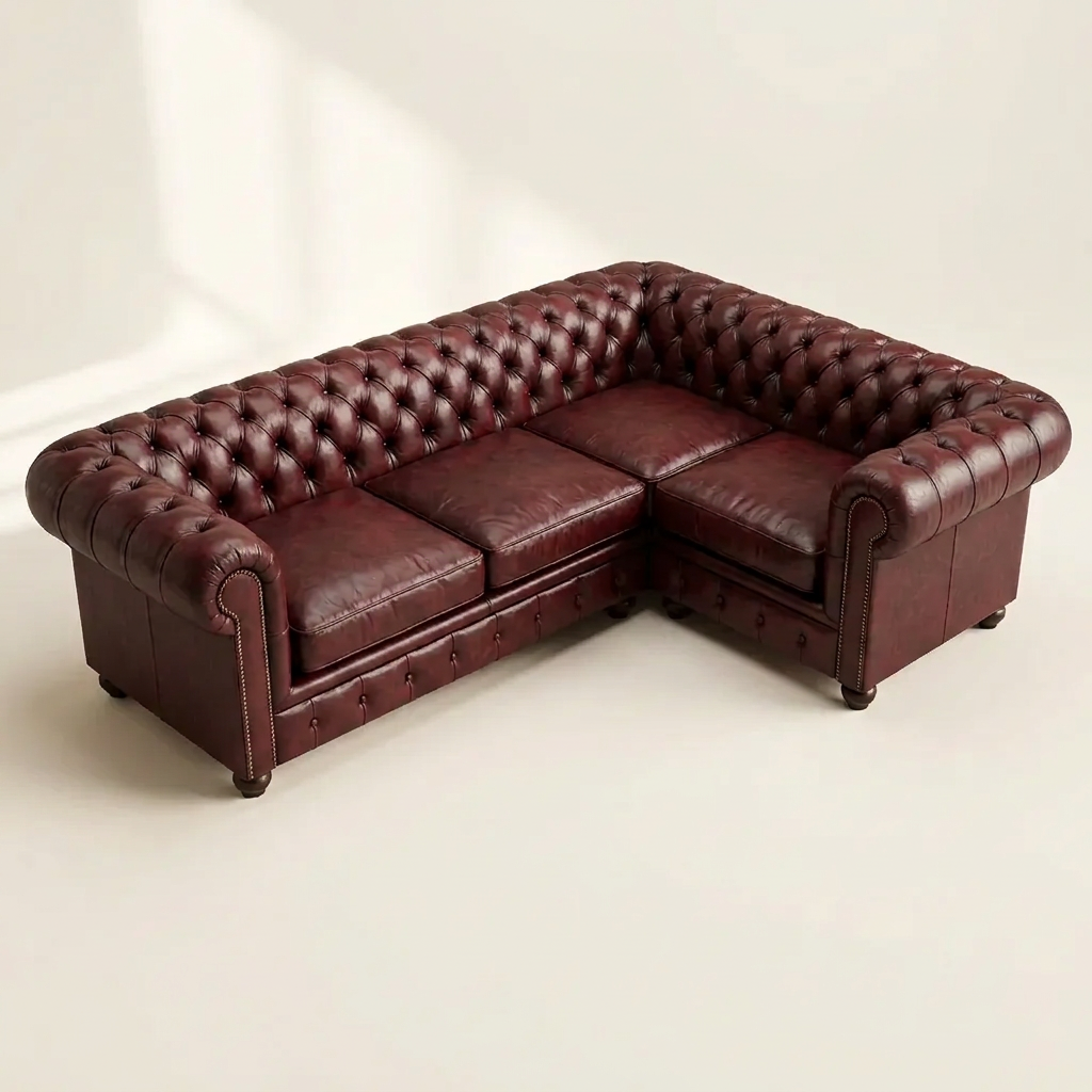 The Oakmere Corner 4-seater L-shaped Chesterfield corner sofa in Oxblood Red leather, deep-buttoned with brass stud trim and turned bun feet